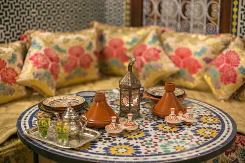 a table with a moroccan tea set on it at Dar Fes Tresor in Fès