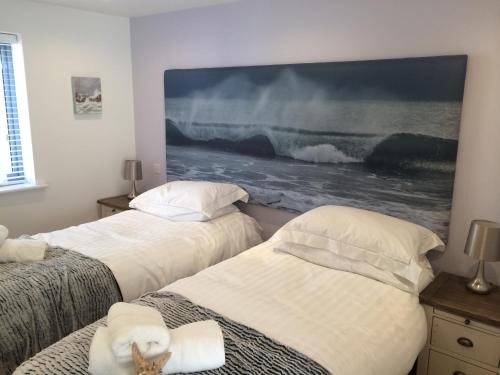 מיטה או מיטות בחדר ב-9 Sandpiper Cottages