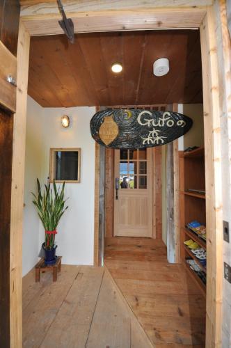 a surfboard hanging from the ceiling of a room at Gufo no Mori Kamifurano in Kami-furano