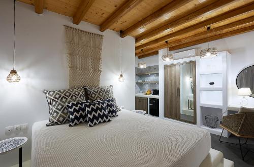 a bedroom with a bed with two pillows on it at Litore Suite in Pollonia