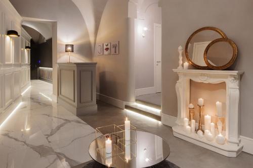 a living room with a glass table and a fireplace at Quattro Canti Suites in Catania