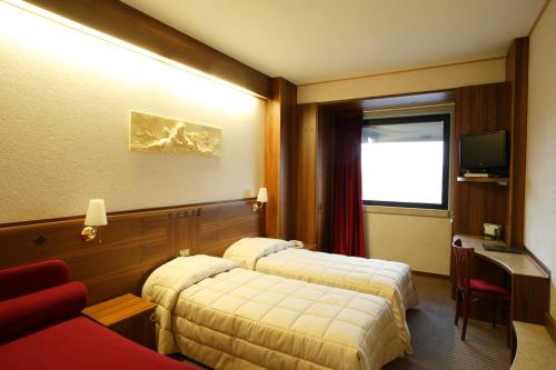 Postel nebo postele na pokoji v ubytování Hotel Alexander