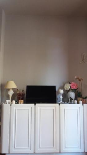 a white cabinet with a laptop on top of it at sole mare versilia in Cinquale