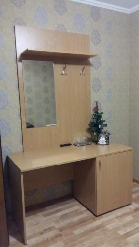 a desk with a christmas tree on top of it at Zlata Praha in Mukacheve
