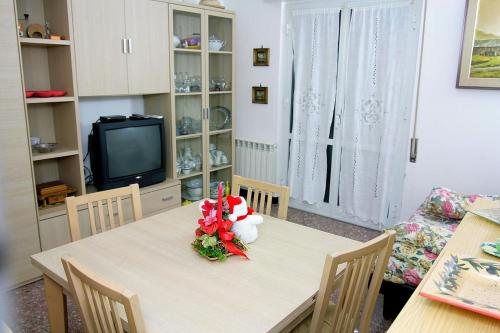 een eetkamer met een tafel en een televisie bij Relax e mare in Savona