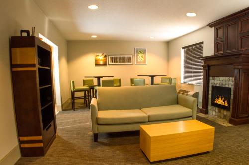 a living room with a couch and a fireplace at Country Inn & Suites by Radisson, Dayton South, OH in Dayton