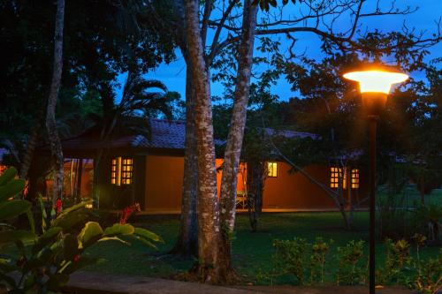 a street light in front of a house at night at Natural Lodge Caño Negro in Caño Negro
