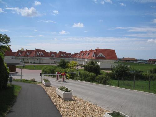 a street with a row of houses in the background at Gólya Villa Park in Velence