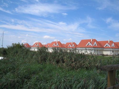 a row of houses with red roofs on a hill at Gólya Villa Park in Velence
