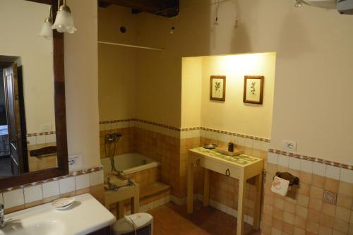 a bathroom with a sink and a tub and a toilet at Attico Panoramico in dimora storica in Canino