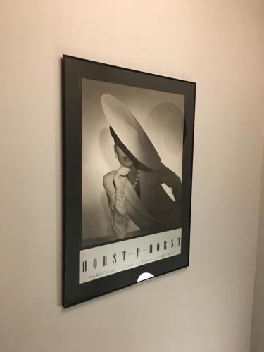 a picture of a woman in a hat on a wall at OurHaus in Beverley