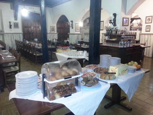 a table with plates of food on top of it at Dogana Vecchia - Hotel & Residence B&B Ristorante & Pizzeria in Trivignano Udinese