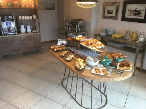 a table filled with different types of bread and pastries at Sol Arrayan Hotel & Spa in Villa La Angostura