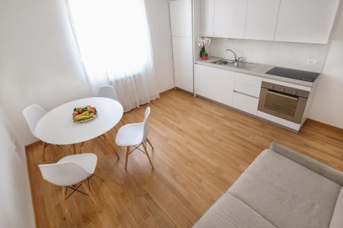 a kitchen and dining room with a white table and chairs at Da Oreste Affittacamere in Fara San Martino