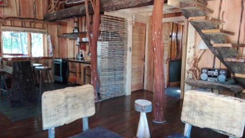 a room with two chairs and a staircase in a cabin at Cabañas Rústicas Pucón Río Trancura in Pucón