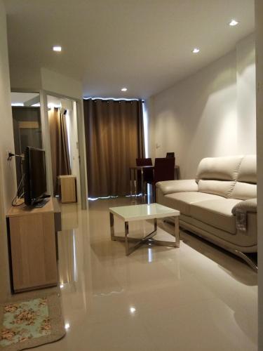 a living room with a couch and a coffee table at Mosaic Condominium A34M by malai in Ban Bua Phut