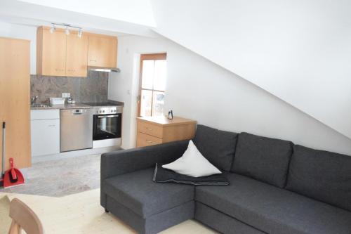 a living room with a couch and a kitchen at Haus Christian in Niederthai