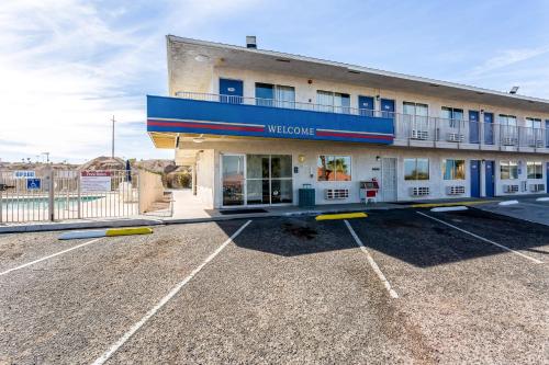 a building in a parking lot in front at Motel 6-Needles, CA in Needles