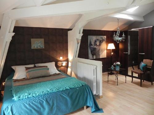 a bedroom with a large bed and a living room at Domaine de Puycarpin in Belvès-de-Castillon