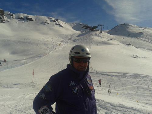 a man is standing on a snow covered mountain at casa del cirillo in Ornica