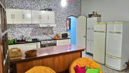 a kitchen with white appliances and a blue refrigerator at Juquehy Brothers House in Juquei