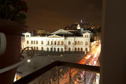 a view of a large white building at night at Hotel Plaza del Teatro in Quito