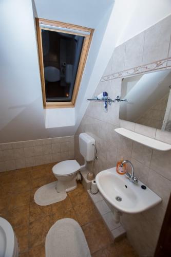 a bathroom with a toilet and a sink at Paulay Borház és Vendégház in Tokaj