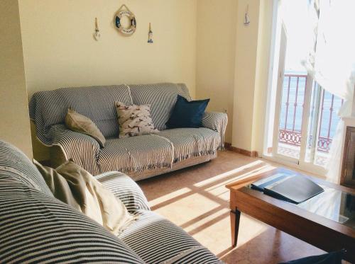 a living room with a couch and a table at Casa Buenavista in Almuñécar
