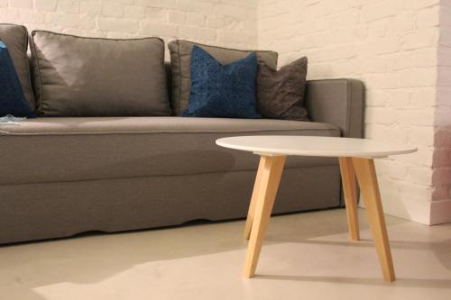 a coffee table in front of a couch at Momo Apartment in Belgrade