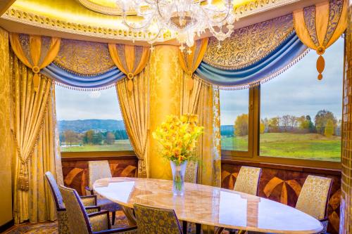 a dining room with a table and a large window at King's Resort - casino and hotels in Rozvadov