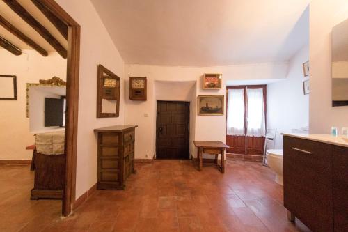 a room with a bathroom with a sink and a door at Palacete Sol de Mayo in Úbeda