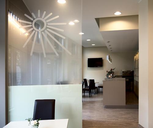 a dining room and kitchen with a ceiling fan at Albergo Sole in Mariano Comense