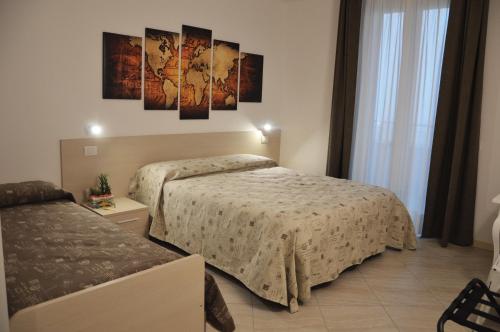 a hotel room with two beds in a room at Il Sorriso in Negrar