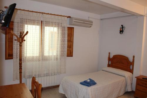 En eller flere senge i et værelse på Posada Manolon