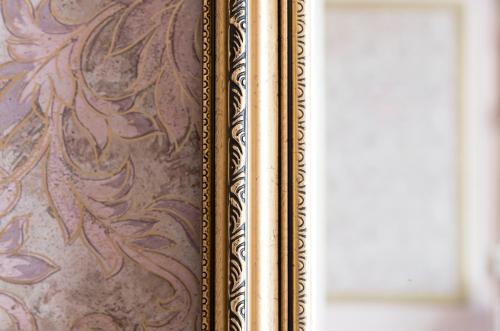 a book with a gold frame next to a window at Hotel Fidder - Patrick's Whisky Bar in Zwolle