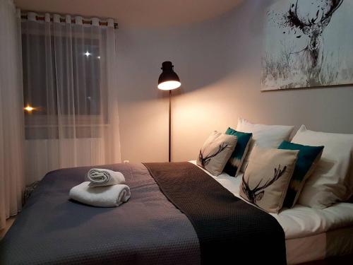 a bedroom with a bed with a white towel on it at VIP Apartamenty Stara Polana 2 in Zakopane