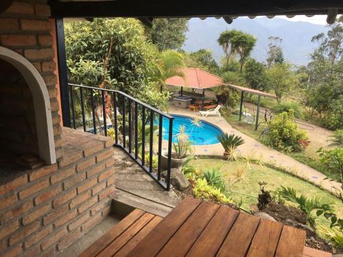 a balcony of a house with a swimming pool at NUESTRA CASA -OUR HOME Yunguilla Valley by A2CC in Tobachirin