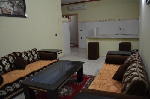 a living room with a couch and a table at Almounia Hotel & Spa in Taroudant