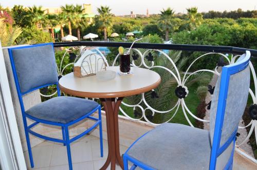 a small table and two chairs on a balcony at Almounia Hotel & Spa in Taroudant