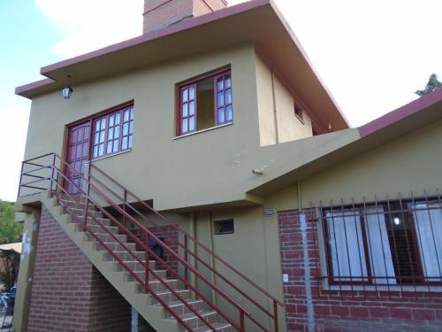 a house with a staircase in front of it at Posada Rivera in San Salvador de Jujuy