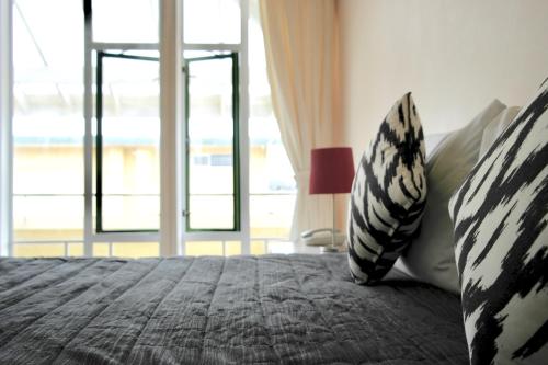 a bedroom with a bed and a large window at Bucklands Beach Waterfront Motel in Auckland