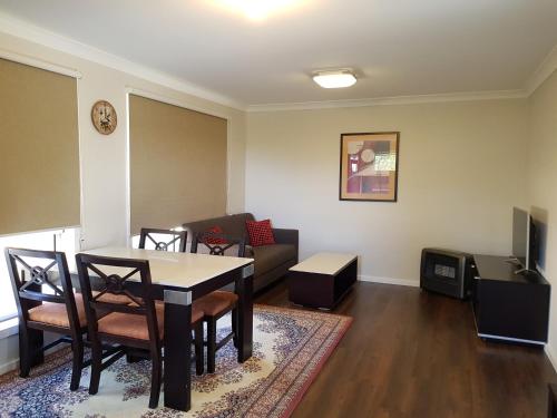 a living room with a table and chairs and a couch at Blue on McNab in Katoomba