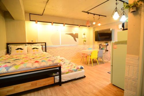 a bedroom with a bed and a dining room with a table at Residence Unicorn in Seoul