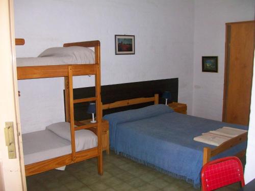 a bedroom with two bunk beds and a blue bed at Hosteria Columbia in Mina Clavero