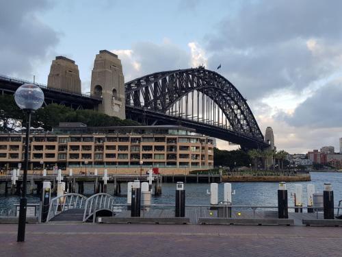 a bridge over the water in front of a building at Macquarie Park Paradise-City View in Sydney