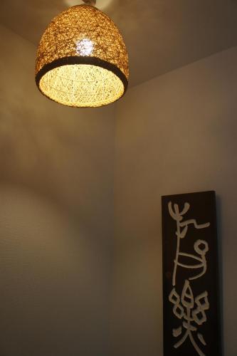 a light hanging from a ceiling with a chandelier at Lucy's House 横浜中華街 House2 in Yokohama