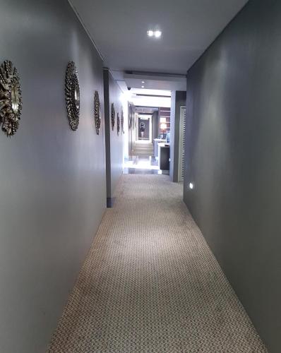 a hallway with a long corridor with a hallway at Heaven on Earth - Blouberg Beachfront Self-catering Apartment in Bloubergstrand