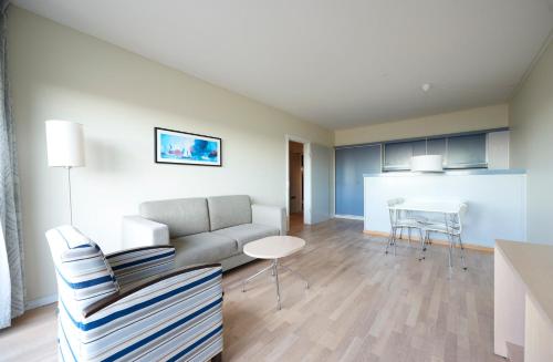 a living room with a couch and a table at Hotel Marina in Vedbæk