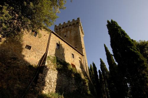 a building with a tower on top of it at Castello Di Gargonza in Monte San Savino
