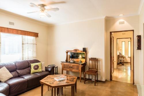 una sala de estar con un sofá y una mesa en Karoo Lodge, en Prince Albert